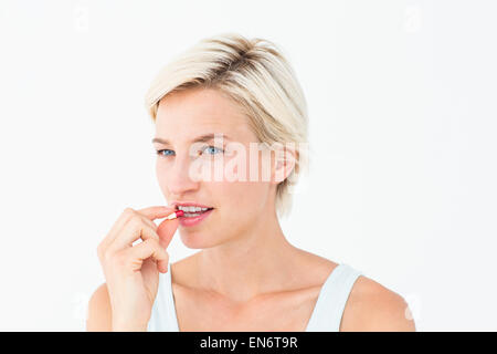 Pretty woman taking pills Stock Photo