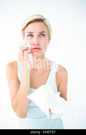 Crying pretty woman holding tissues Stock Photo