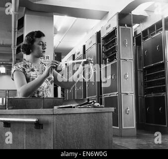 An operator at work using 'LEO' the electronic computer which is run along with another two operators and engineers at Lyons Electronic Office in Cadby Hall, Kensington. The computer deals with payrolls, Lyons shop requirements, stock control, tea blendin Stock Photo