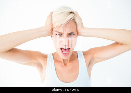 Angry woman screaming and holding her head Stock Photo