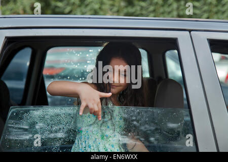 Little girl drawing on glass Stock Photo