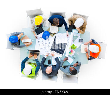 Group Of Construction Site Workers On A Conference Table Holding A Meeting Stock Photo