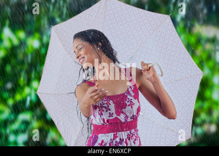 Woman with umbrella enjoying the rain Stock Photo