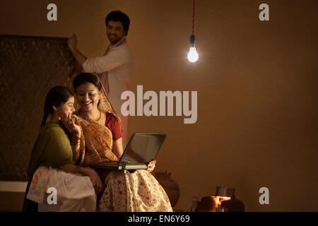 Rural mother and daughter with laptop Stock Photo
