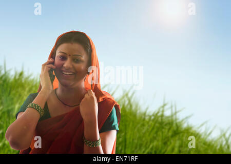 Rural woman talking on mobile phone Stock Photo