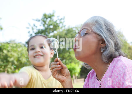 Senior woman blowing bubbles Stock Photo