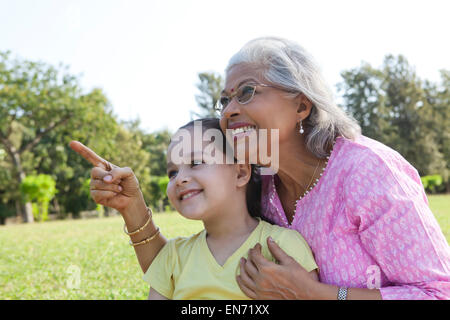 Grandmother pointing something out to granddaughter Stock Photo