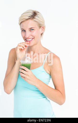 Beautiful woman drinking green juice Stock Photo