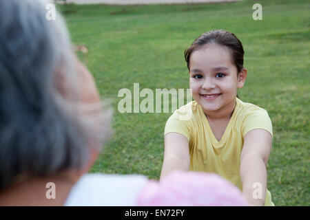 Portrait of girl playing with grandmother Stock Photo