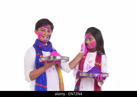 Portrait of a boy putting holi colour on a girl Stock Photo