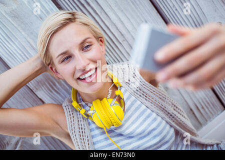 Pretty blonde woman taking selfie Stock Photo