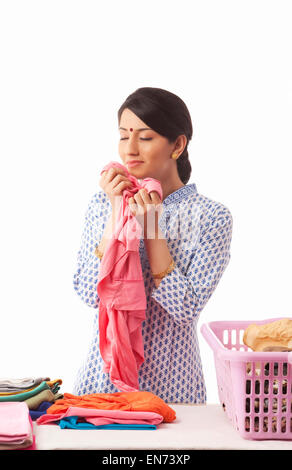 Young woman sorting out clothes Stock Photo
