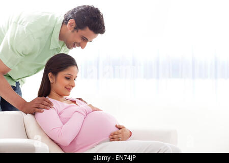 Man looking at pregnant womans belly Stock Photo