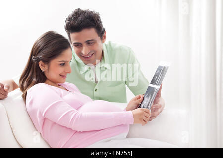 Couple looking at ultrasound scans Stock Photo