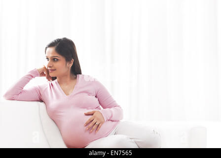 Pregnant women sitting on the sofa to have a rest Stock Photo - Alamy