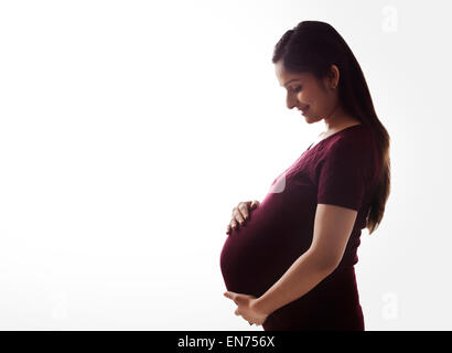 Pregnant woman holding her stomach Stock Photo