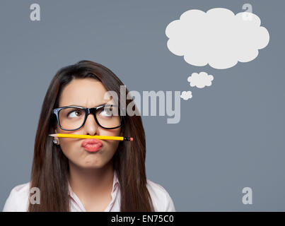 Female executive balancing pencil on lip Stock Photo