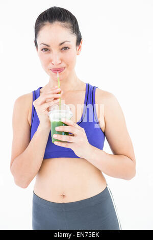 Attractive woman drinking green juice Stock Photo