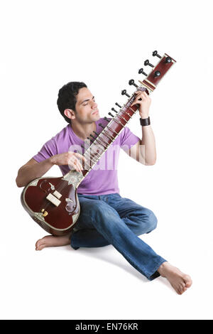 Young man playing the sitar Stock Photo