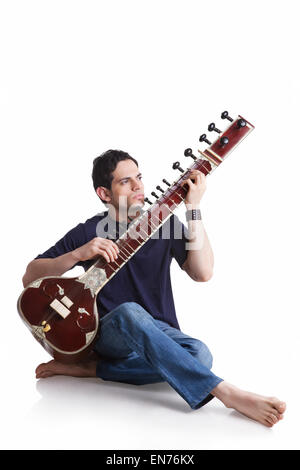 Young man playing the sitar Stock Photo