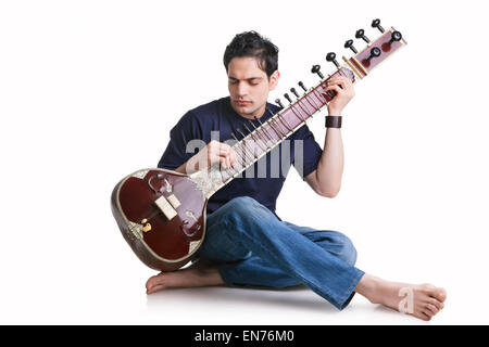 Young man playing the sitar Stock Photo