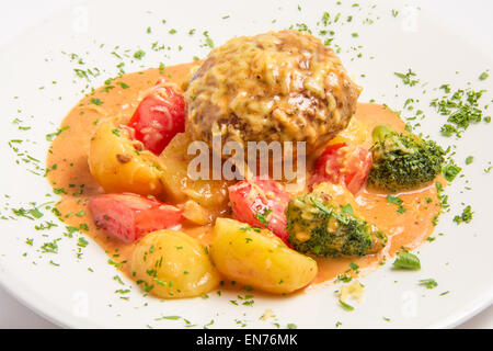 klops of veal with bacon, capers, grated cheese in a creamy sauce Stock Photo