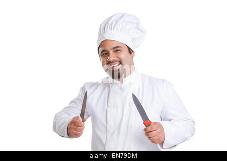 Portrait of chef holding knives Stock Photo