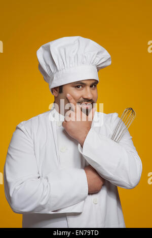 Portrait of chef holding wire whisk Stock Photo