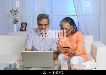 Husband and wife working on the laptop Stock Photo