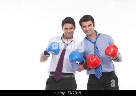 Portrait of two male executives with boxing gloves Stock Photo