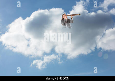 Composite image of businesswoman looking through a telescope Stock Photo