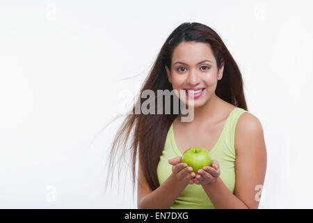 Portrait of woman holding an apple Stock Photo