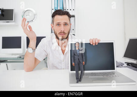 Composite image of businessman standing looking at camera Stock Photo