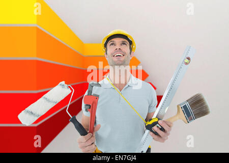 Composite image of worker holding various equipment over white background Stock Photo