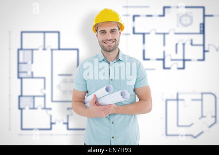 Composite image of happy male architect holding blueprints Stock Photo