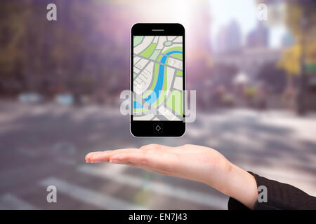 Composite image of hand showing map app on phone Stock Photo