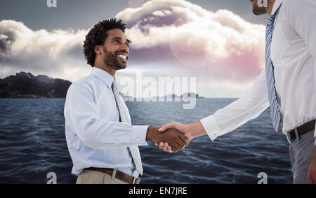 Composite image of two businessmen shaking hands in office Stock Photo