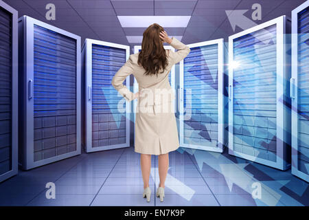 Composite image of businesswoman standing back to camera with hand on head Stock Photo