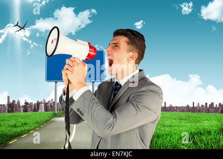 Composite image of businessman with megaphone Stock Photo