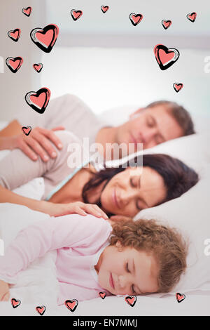 Composite image of family sleeping on the bed Stock Photo