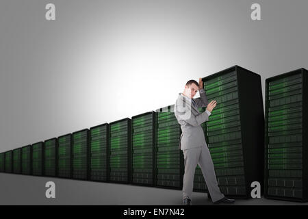 Composite image of portrait of young businessman pushing a blank panel Stock Photo