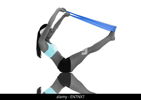 Composite image of fit young woman exercising with a blue yoga belt Stock Photo