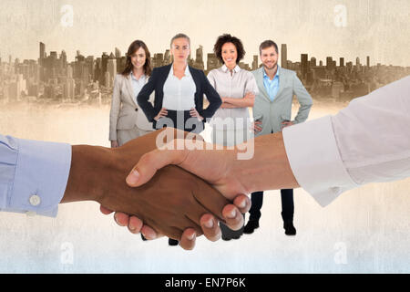 Composite image of close-up shot of a handshake in office Stock Photo