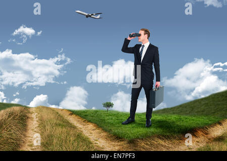 Composite image of businessman looking through binoculars Stock Photo