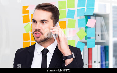 Composite image of smart businessman speaking on the phone Stock Photo