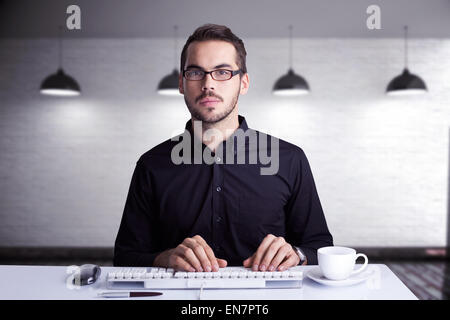 Composite image of focused businessman typing on keyboard Stock Photo