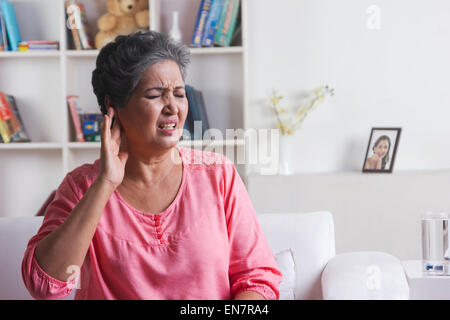 Old woman with pain in ear Stock Photo