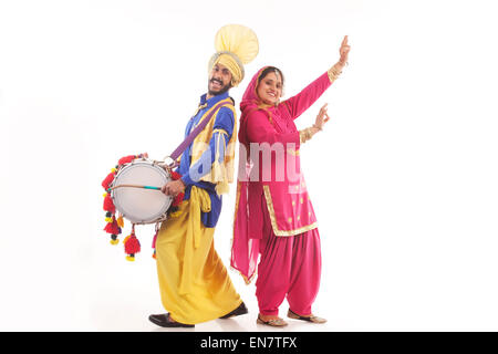 Portrait of Sikh couple doing bhangra dance Stock Photo