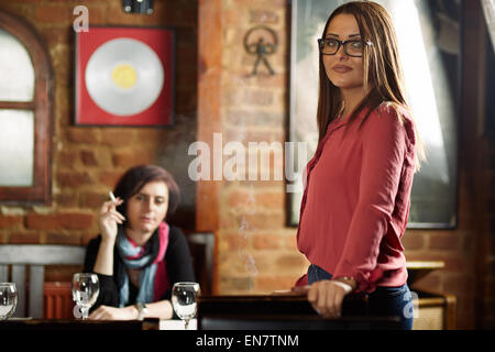 Two girlfriends in a pub having a girls only date Stock Photo