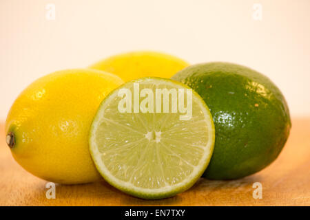 Lemons and Limes Isolated on wooden surface Stock Photo